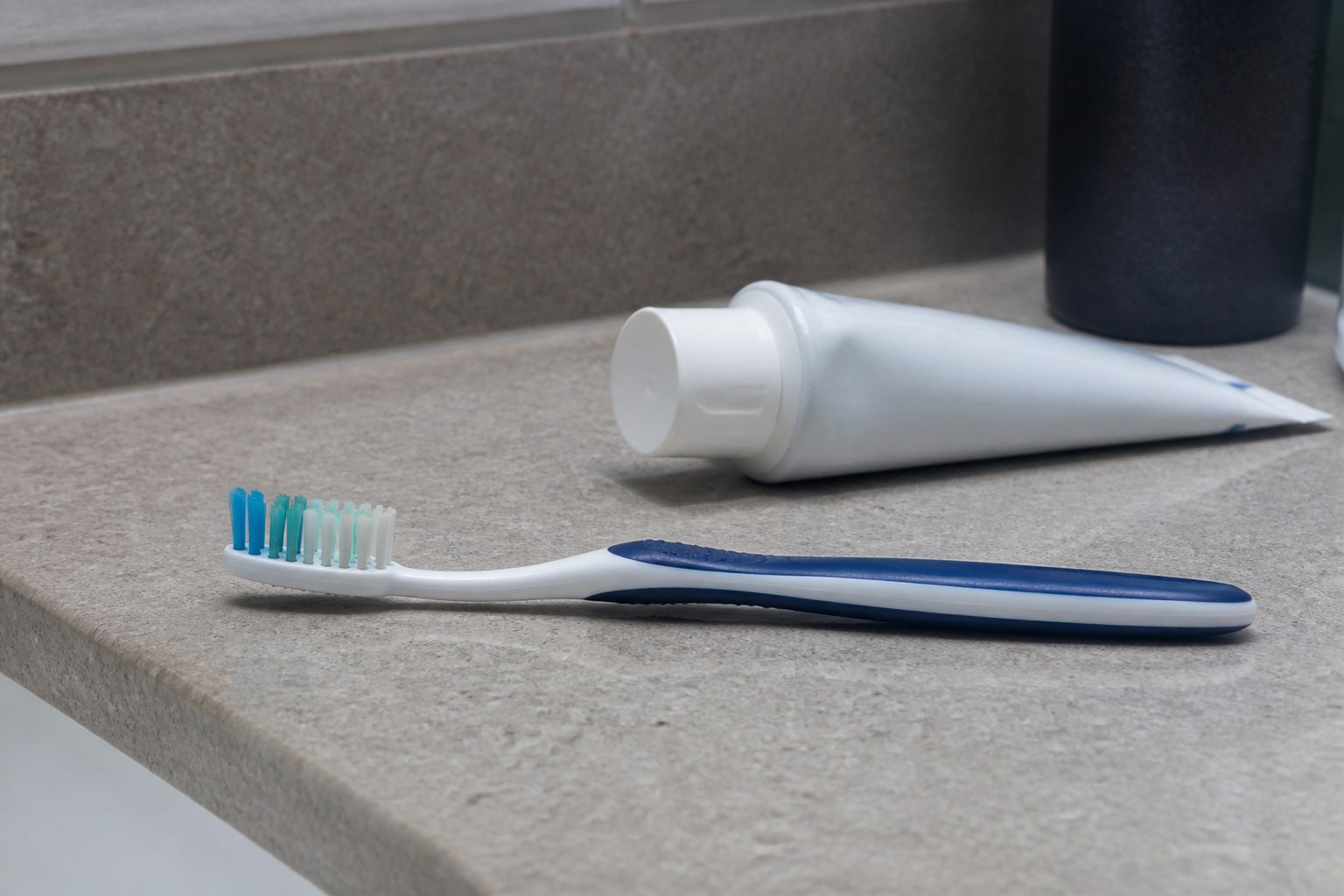 Soft-bristled toothbrush and non-abrasive toothpaste on a bathroom countertop